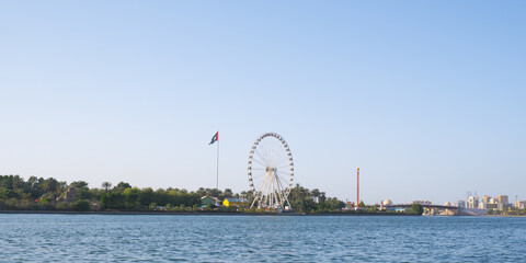 Sharjah cityscape with UAE flag.