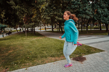 Fototapeta premium Women in sports clothes running in a modern urban environment. The concept of a sporty and healthy lifestyle