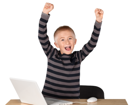 Young boy working on laptop celebrating with tongue out