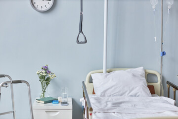 Background image of hospital room interior with bed and flowers, copy space
