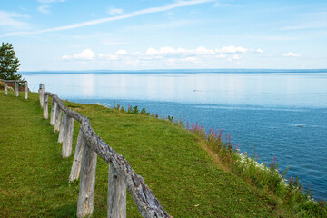 Ocean shoreline bordered by a wooden fence