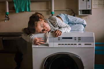 Eco-conscious teenage girl waits in common laundry. Sustainability and responsible living. Efforts to save resources, conserve water, energy, and money. Eco-lifestyle in action