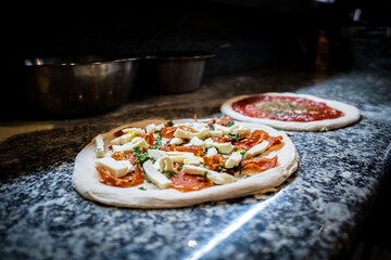 Pizza napoletana in preparation by pizzaiolo