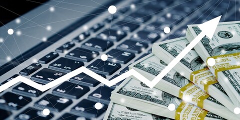 Glowing graph and money bills on computer