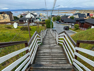 A wooden stairway with the harbour of Ushuaia in the background