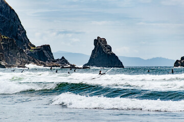 People Surfing and swimming on Short Sands Beach in Oswald West State Park along the Oregon Coast