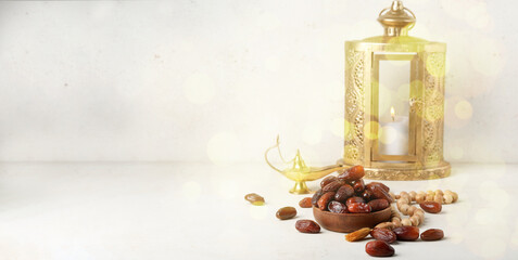 Tasty dates, prayer beads, Aladdin lamp and fanous lantern on light background with space for text