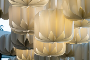 An unusual designer chandelier made of multicolored paper made by hand. Large paper lamps in a...