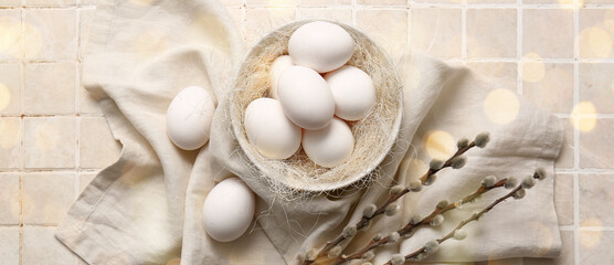 Bowl of Easter eggs and pussy willow branches on light background
