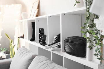 Shelving unit with shoes and bag in dressing room