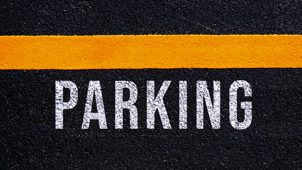 Parking written and yellow line on the road in middle of the asphalt road, Parking word on stree
