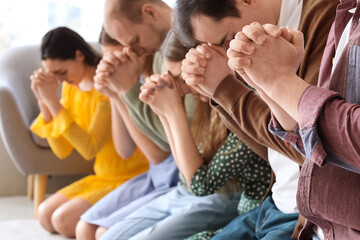 Obraz premium Group of people praying with Holy Bible on floor, closeup
