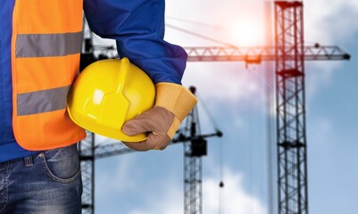Engineer hold a hardhat at work on construction