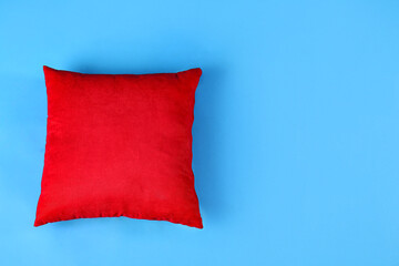 Red pillow on blue background