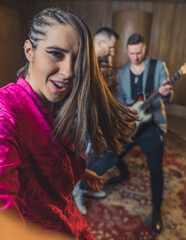 Young female singer holding a selfie camera during the rehearsal. High quality photo