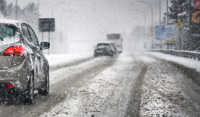 Extreme snowfall on street with snowy cars.