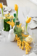 Festive table setting with baby chicken and bunny for Easter celebration