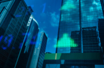 Financial stock exchange market display screen board on the street with and city light reflections, selective focus
