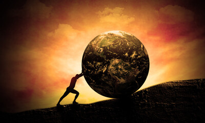 Young man Pushing Earth Globe up to hill. Sunset scene. Concept of Heavy tasks and Global problems, Difficulty and Hard Work. World Responsibility and Sisyphus 