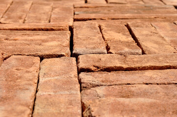 Pile of red bricks texture background selective focus