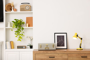 Spring atmosphere. Chest of drawers and shelves with stylish accessories in room, space for text
