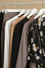 Women's Clothes. Close up image of clothes rack with stylish and elegant clothes in fashion atelier. Minimalist fashion blog concept.	