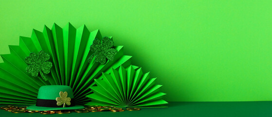 Banner template for St Patrick's Day. Paper folding fans, leprechauns hat and clover leaves on...