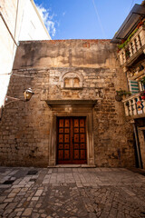 Picturesque narrow street with stone houses. Trogir, Dalmatia, Croatia, Europe