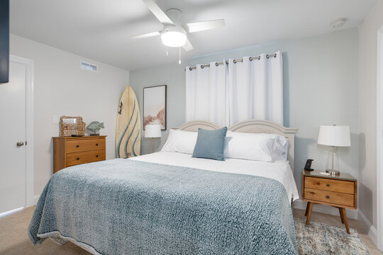 Pale blue bedroom decor with surfboard in vacation rental, Cape Canaveral, Florida