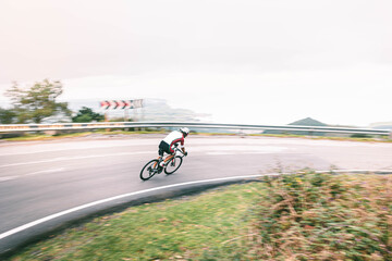 A healthy person riding a bike and descending fast a mountain pass in the middle of Asturias...