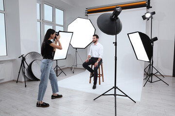 Handsome model posing for professional photographer in studio