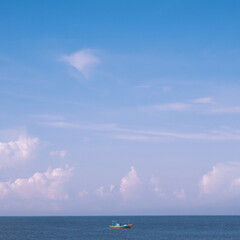 Sea sky cumulus cloud landscape view background. Calm water alone fishing boat. Destination aim progress concept