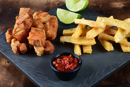 panceta fried pork skin crackling crackling with fries, typical Brazilian foodpanceta fried pork skin crackling crackling with fries, typical Brazilian food