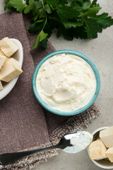 Delicious tofu cheese and spoon on light table, flat lay