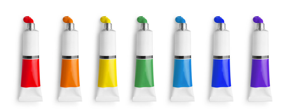 Set of tubes with colorful oil paints on white background, top view