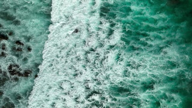 Texture background of waves rolling in turquoise paradise water. Long roll aerial top view surf with foam in sea of cortez mexico