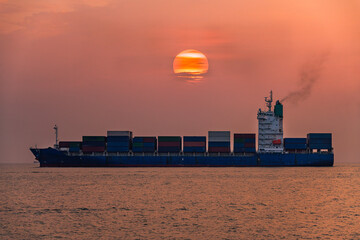 Silhouette Cargo ship Transportation export import logistic business in ocean  with sunset sky...