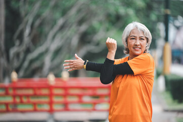 white-haired elderly person exercising in the park early in the morning.