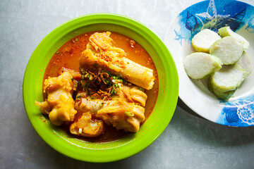 Lontong Kikil, a traditional food from Surabaya, East Java, Indonesia, made from curried cow's leg skin eaten with ketupat or rice wrapped in leaves.