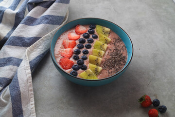 Smoothie bowl with fresh blueberries, kiwi, strawberry, and chia seeds

