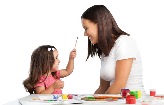 Happy young mother and daughter painting