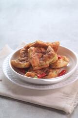 Martabak Mesir or Martabak Kubang is a snack made from flour dough containing eggs, seasoned meat, and leeks and served with vinegar sauce.