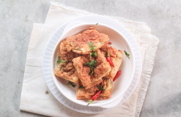 Martabak Mesir or Martabak Kubang is a snack made from flour dough containing eggs, seasoned meat, and leeks and served with vinegar sauce.