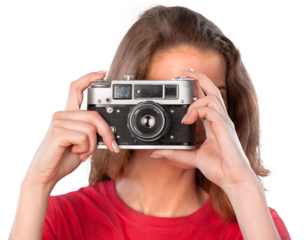 Pretty young woman holding camera isolated on white background