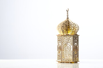 decorative lantern of mosque shape with light inside on white background