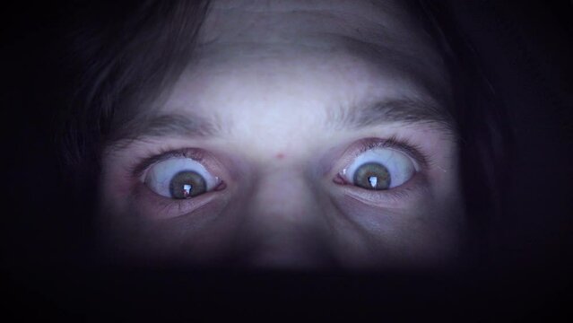 Man obsessed with scrolling in a dark environment. Closeup.