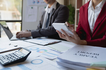 A group of Asian businessmen is meeting to discuss financial income in a real estate project. There is an evaluation calculation with a team of financial advisors to analyze with investors.