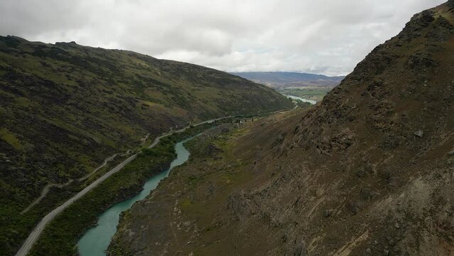 Aerial forward view over river that flows from cromwell to roxburgh. Cycling tour with vineyard around. New Zealand