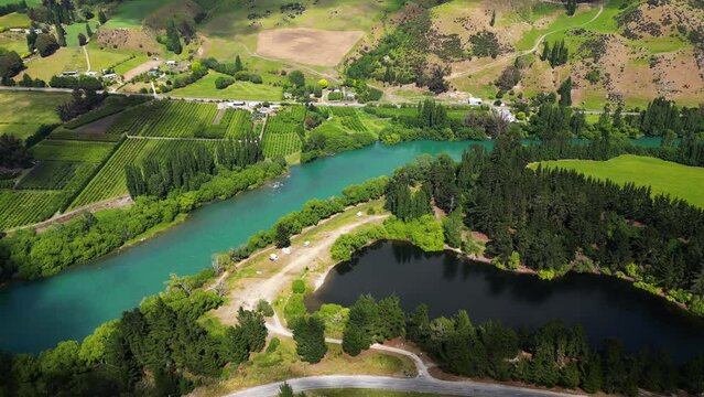 Pinders Pond - Picturesque Serene Lake Surrounded By Lush Greenery On The Banks Of Clutha River In Otago, New Zealand. aerial orbit