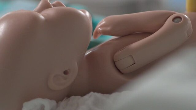 Nursing Student Learns to Care for Baby Doll